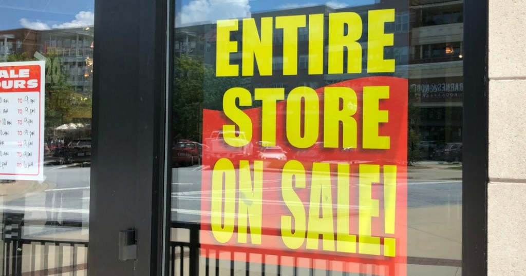 store window with sign for sale