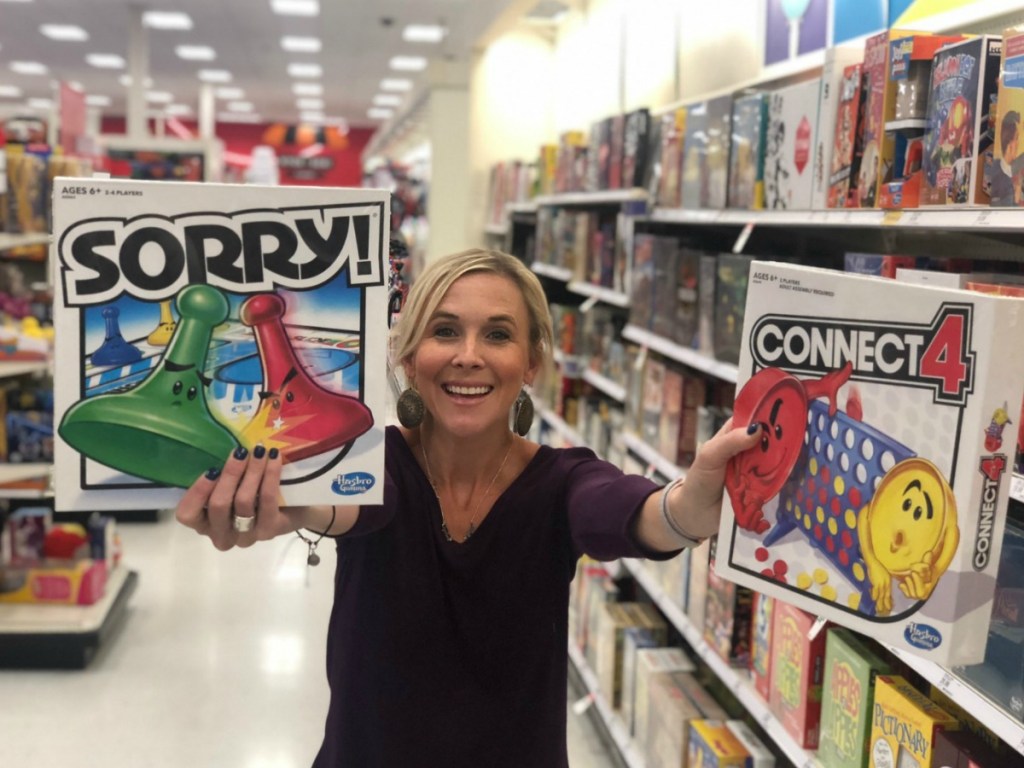 woman holding 2 games in store aisle