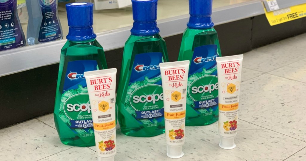 three crest mouthwash and three burts bees toothpastes displayed on store floor