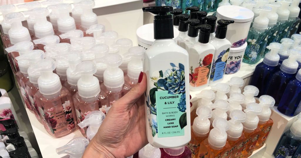 woman hand holding cucumber lily bath and body works hand soap in store