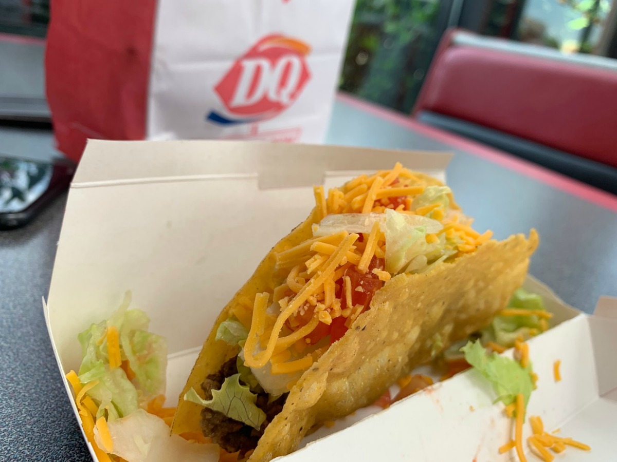 taco from dairy queen in box with dairy queen bag behind it