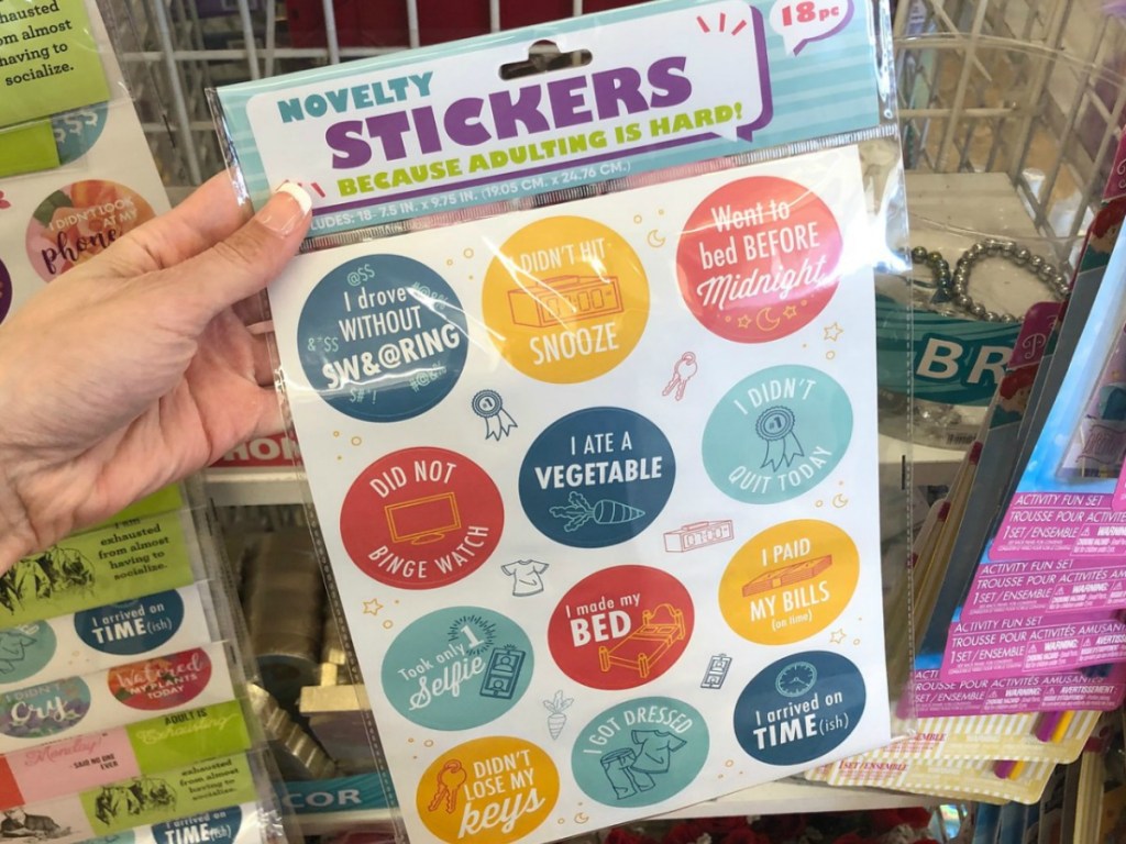hand holding pack of stickers in store