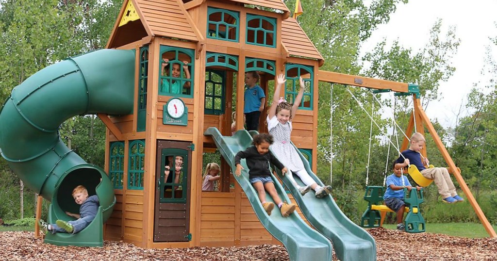 kids playing on big treehouse swingset