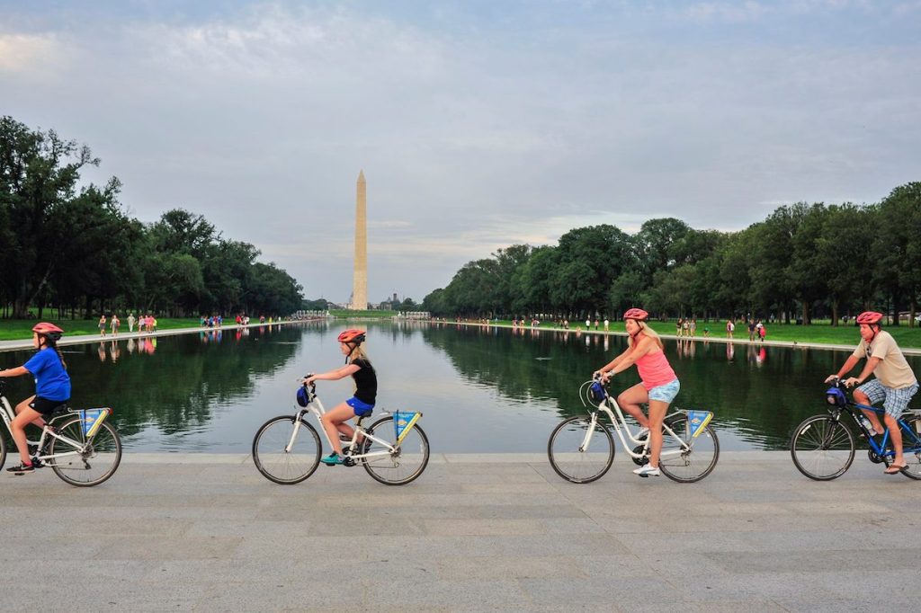 four people riding bikes outside in DC