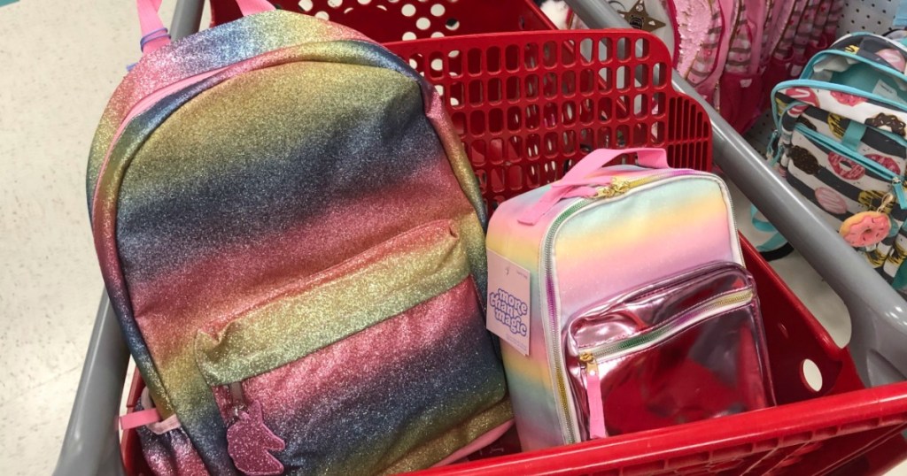 pink backpack and lunchbag in red grocery cart