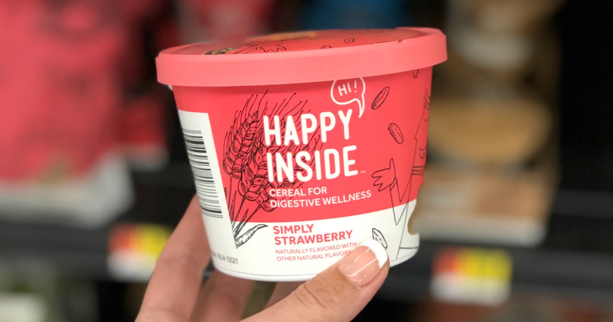 cup of strawberry Happy Inside cereal being held by a hand in a Walmart store