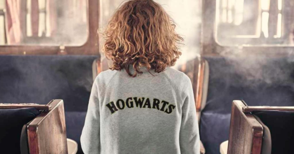 kid wearing a Hogwarts sweatshirt