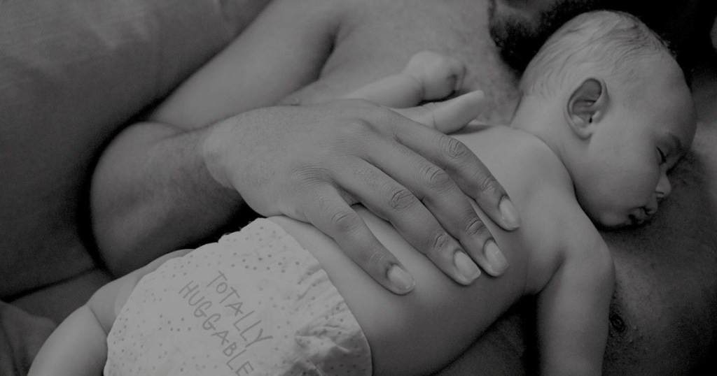 baby asleep in diaper on dad