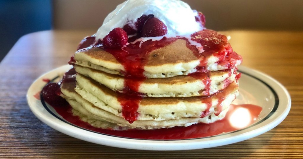 stack of ihop strawberry pancakes with whipped cream
