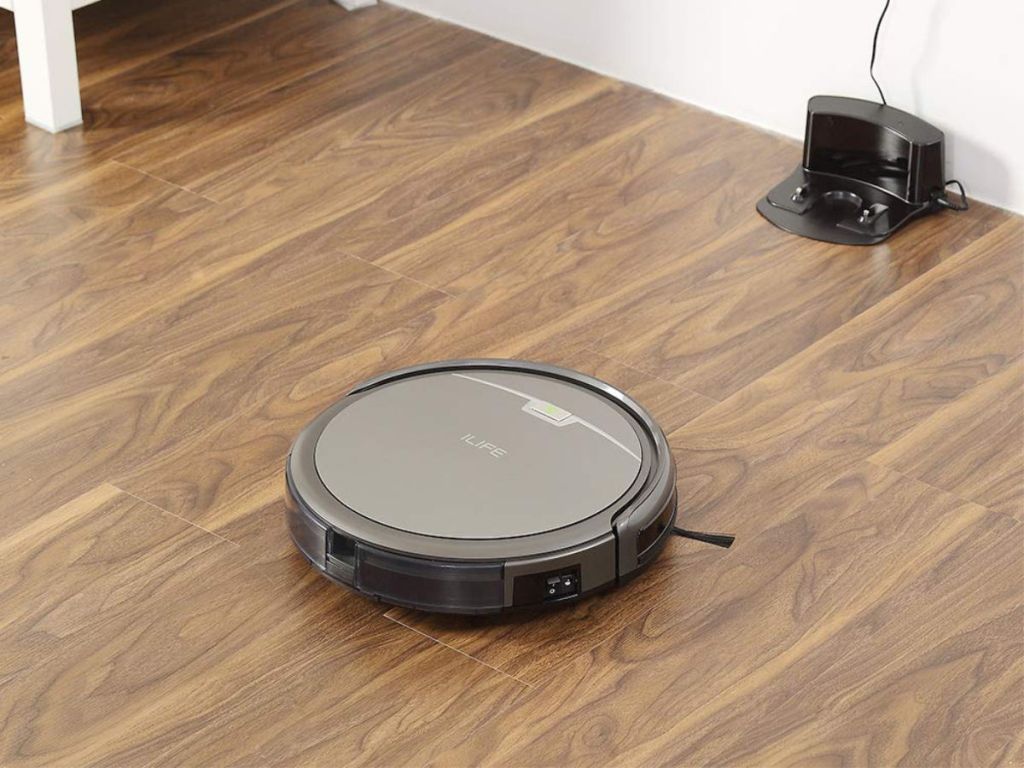 ILIFE A4S Robot Vacuum Cleaner on hardwood floor going to charger