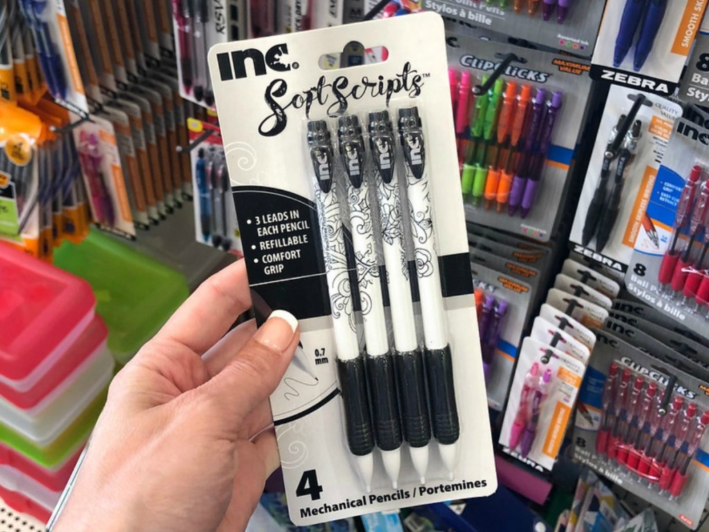 hand holding pack of pencils by store display