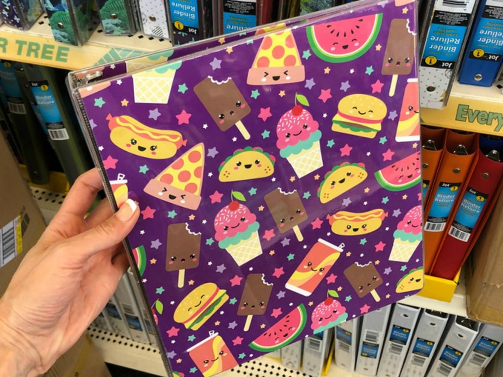 hand holding colorful binder in a store