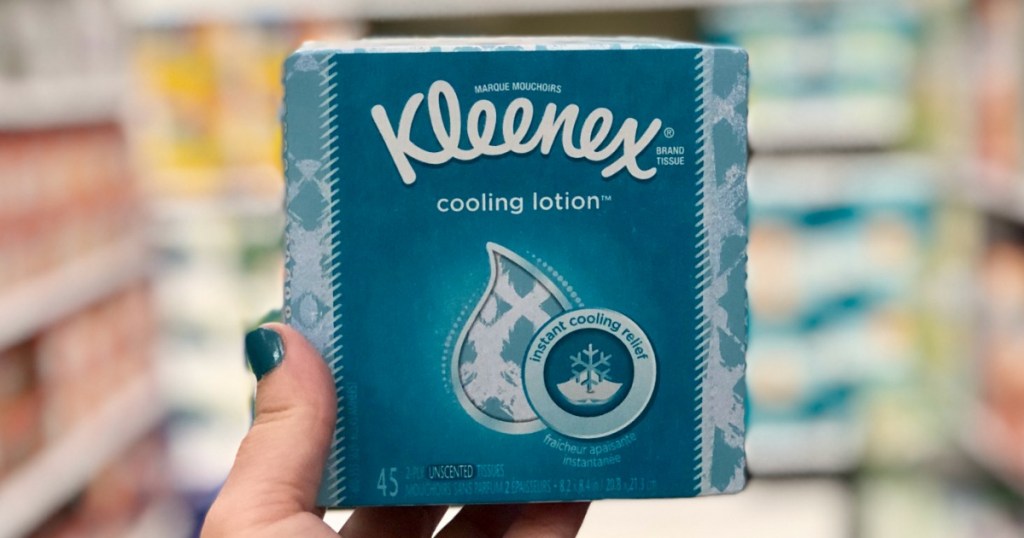 hand holding box of Kleenex tissues in store