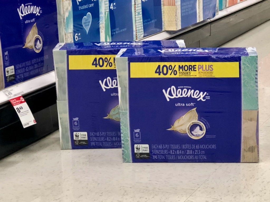 packs of facial tissue on floor near store display