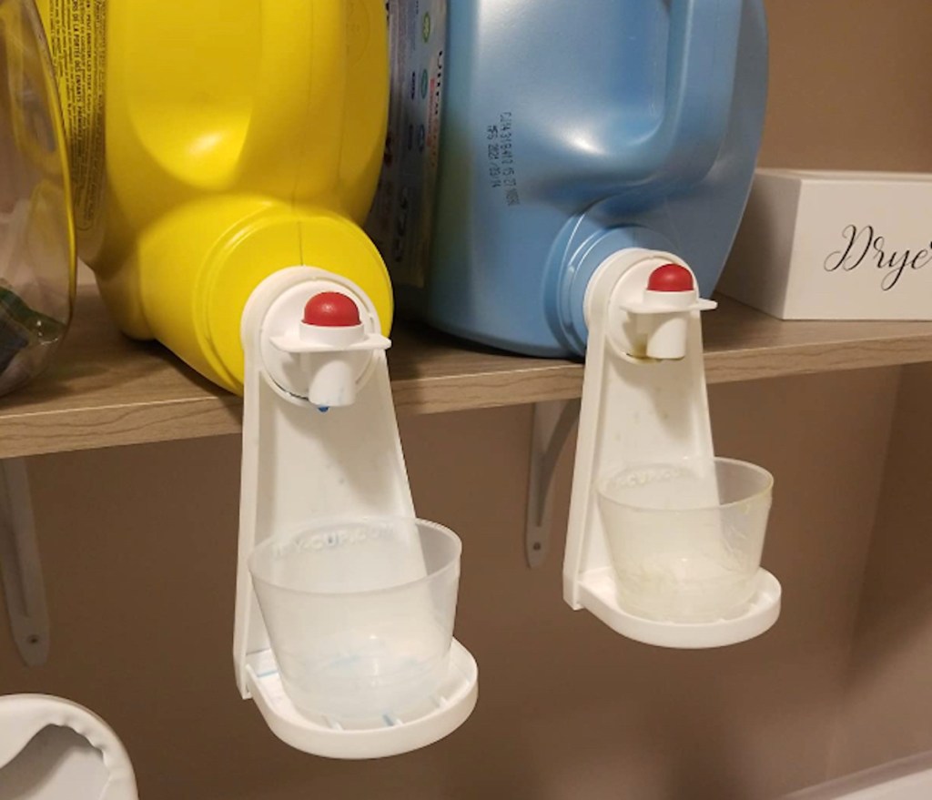 containers of laundry soap with drip catcher attachments