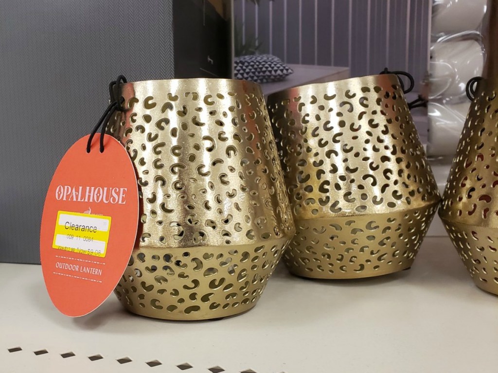 golden candle holder on store shelf with clearance tag