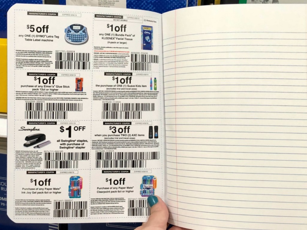 hand holding notebook showing coupons in store