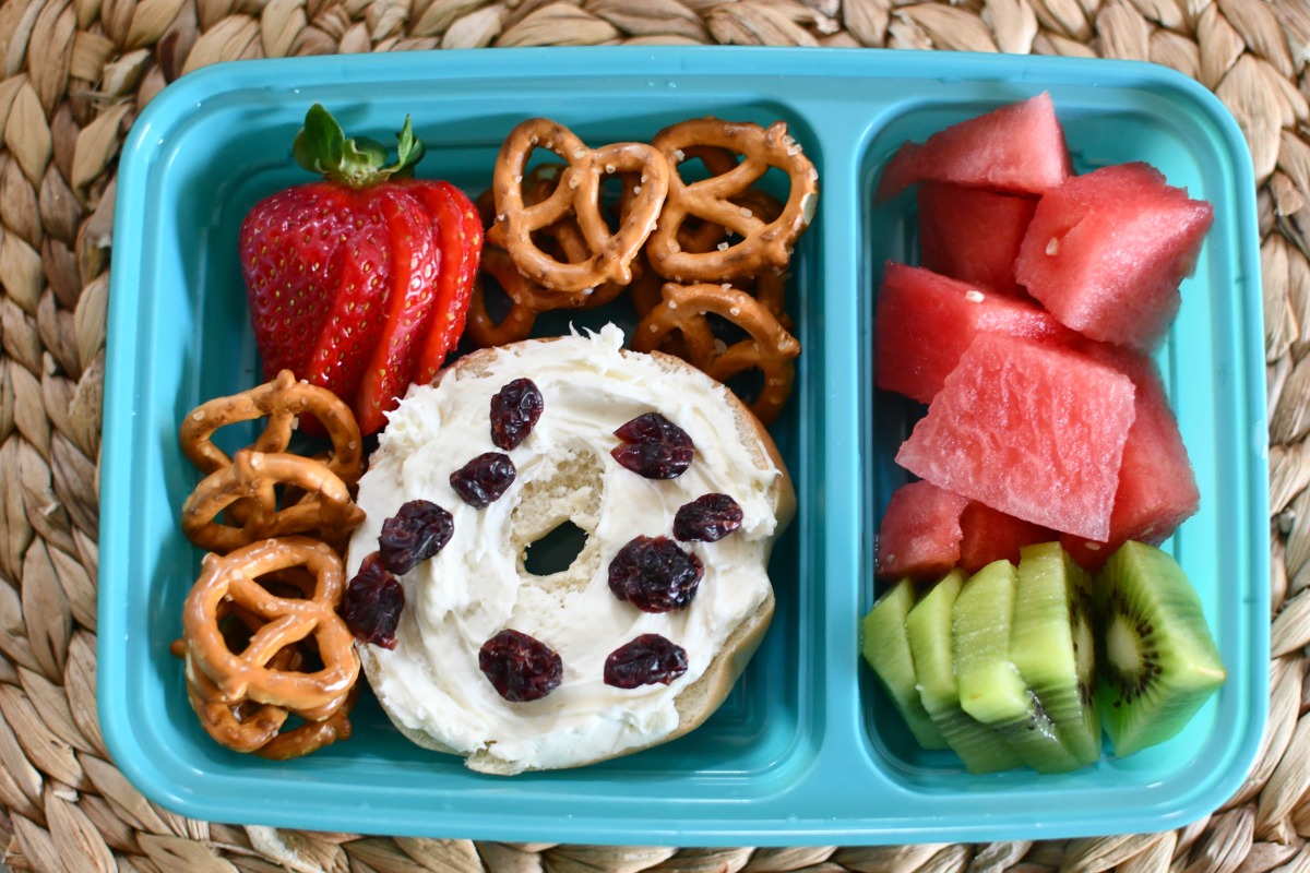 mini bagel lunch for school with fresh fruit in a container 