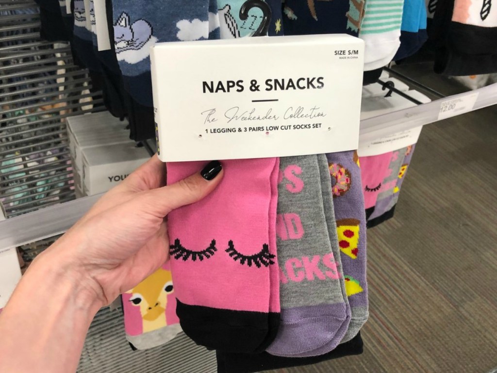 hand holding set of pink socks in store