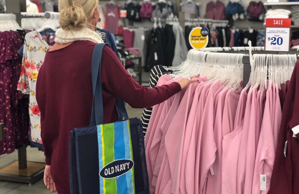 woman shopping in store with old navy tote on shoulder