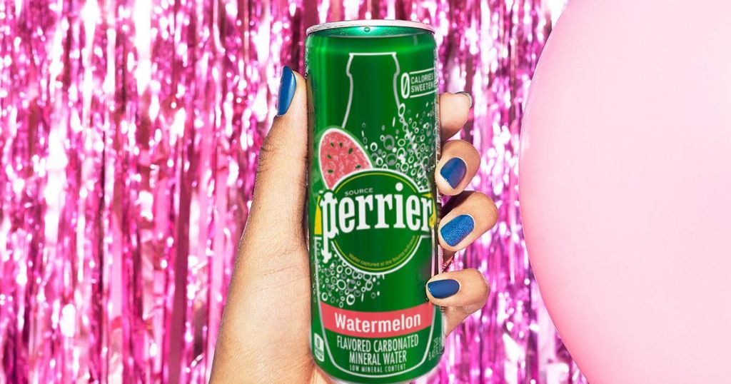 woman hand holding perrier watermelon with pink streamer background