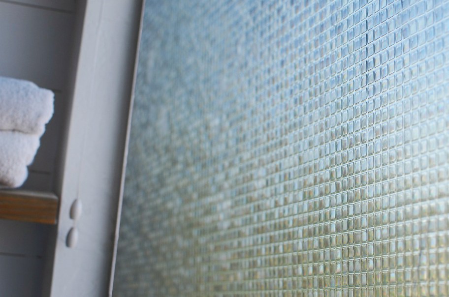 up close view of mosaic amazon privacy window film on glass