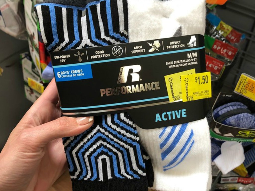 hand holding package of socks in a store