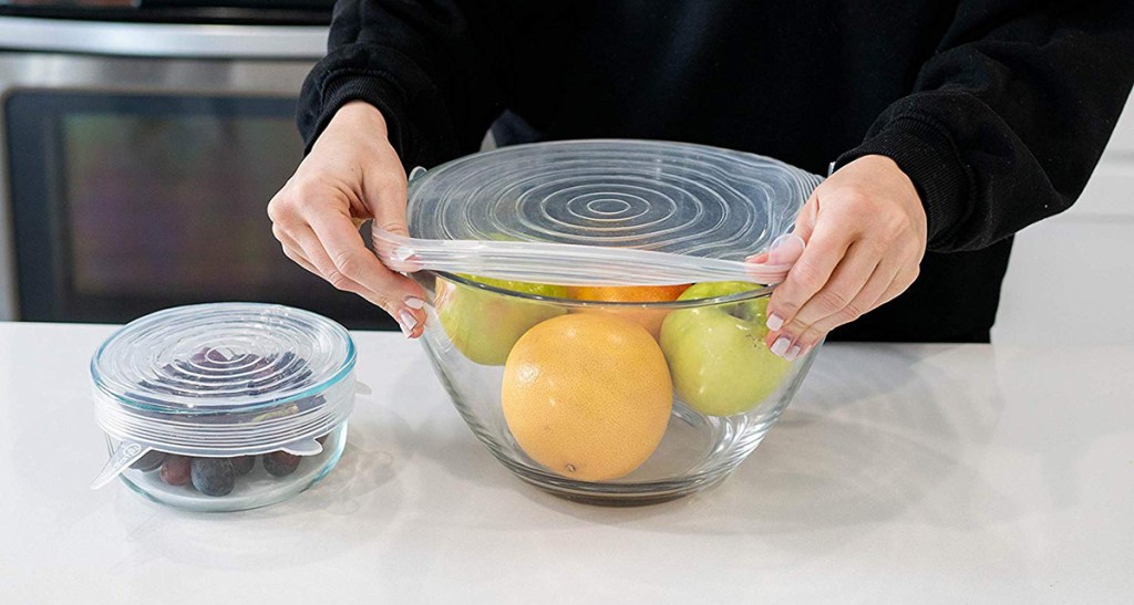 silicone lids being stretched over bowl