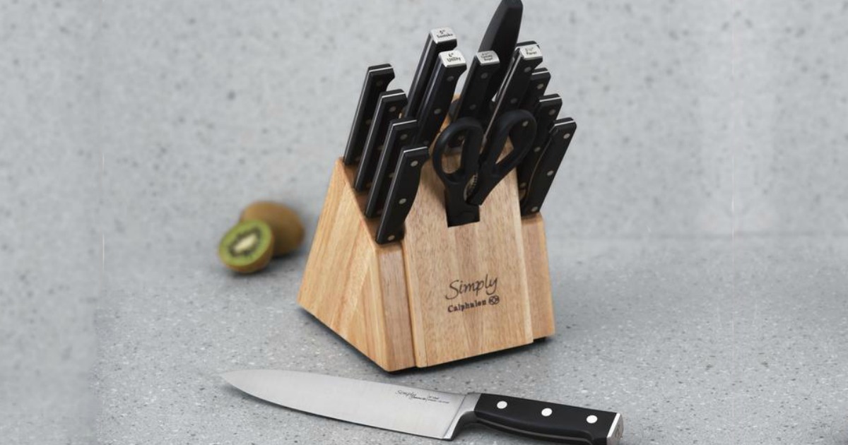 set of black-handled knives in a wood block