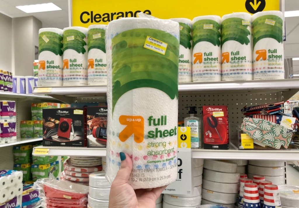 hand holding roll of up and up paper towels in target