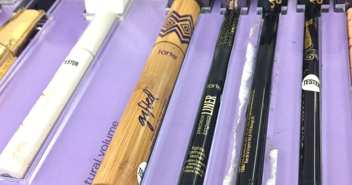 mascara sitting in purple tray in store display