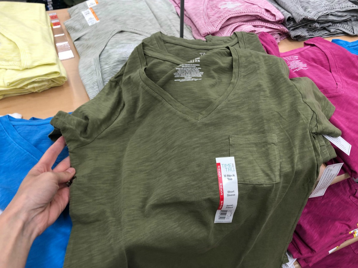 sage colored shirt on table in store