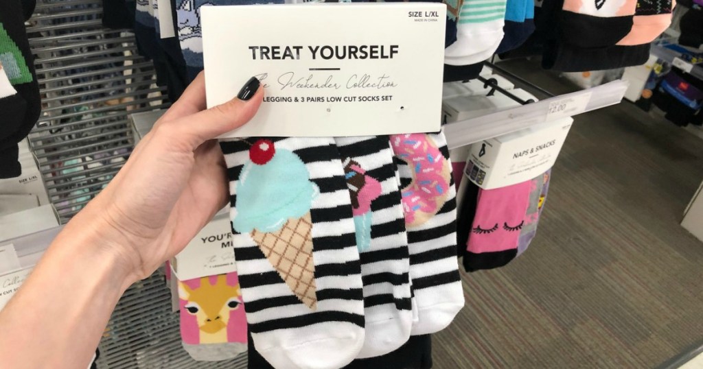 hand holding socks that have ice cream cone on them