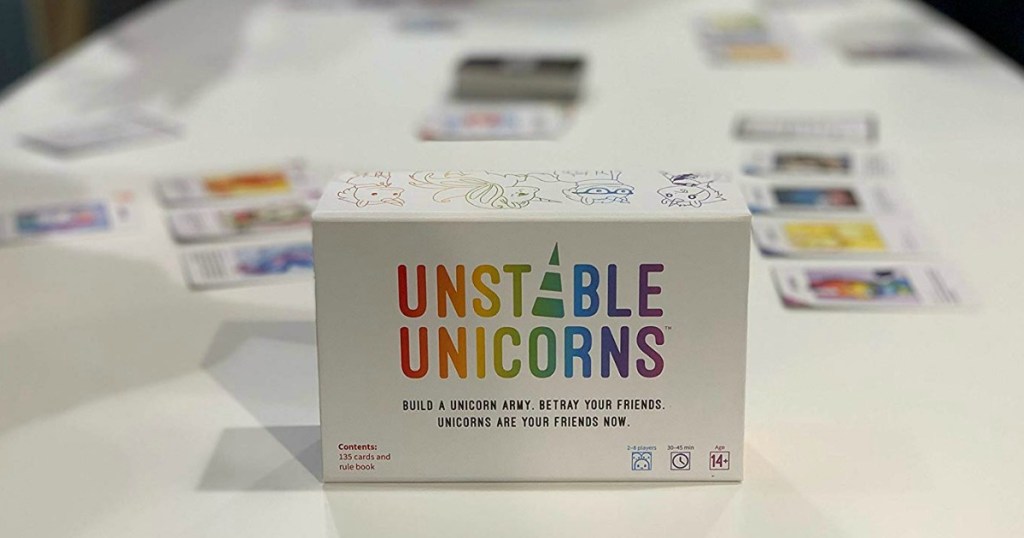 Unstable Unicorns game box and contents set up on table