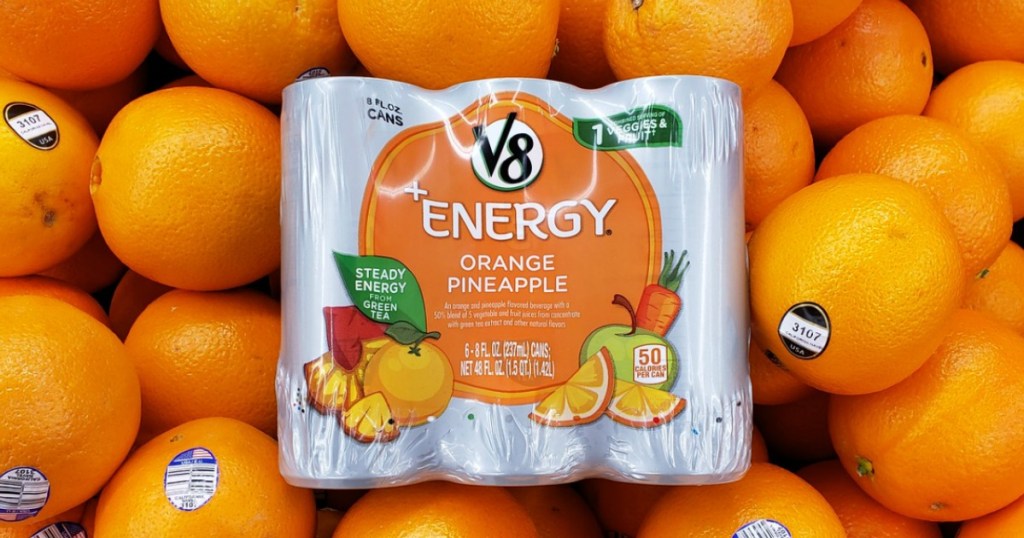 packs of v8 flavored energy drinks on top of oranges