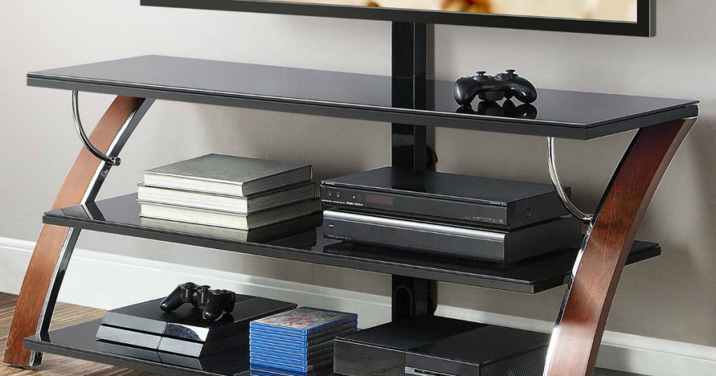 tv stand with books and gaming devices on it