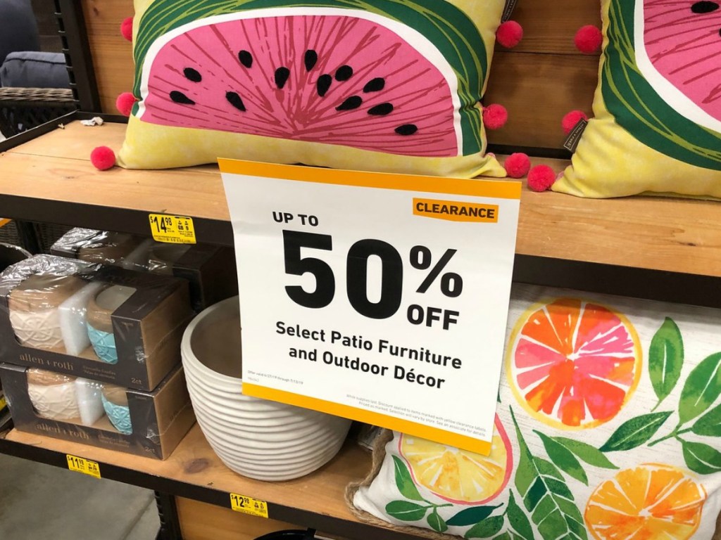sale sign with watermelon pillows behind it