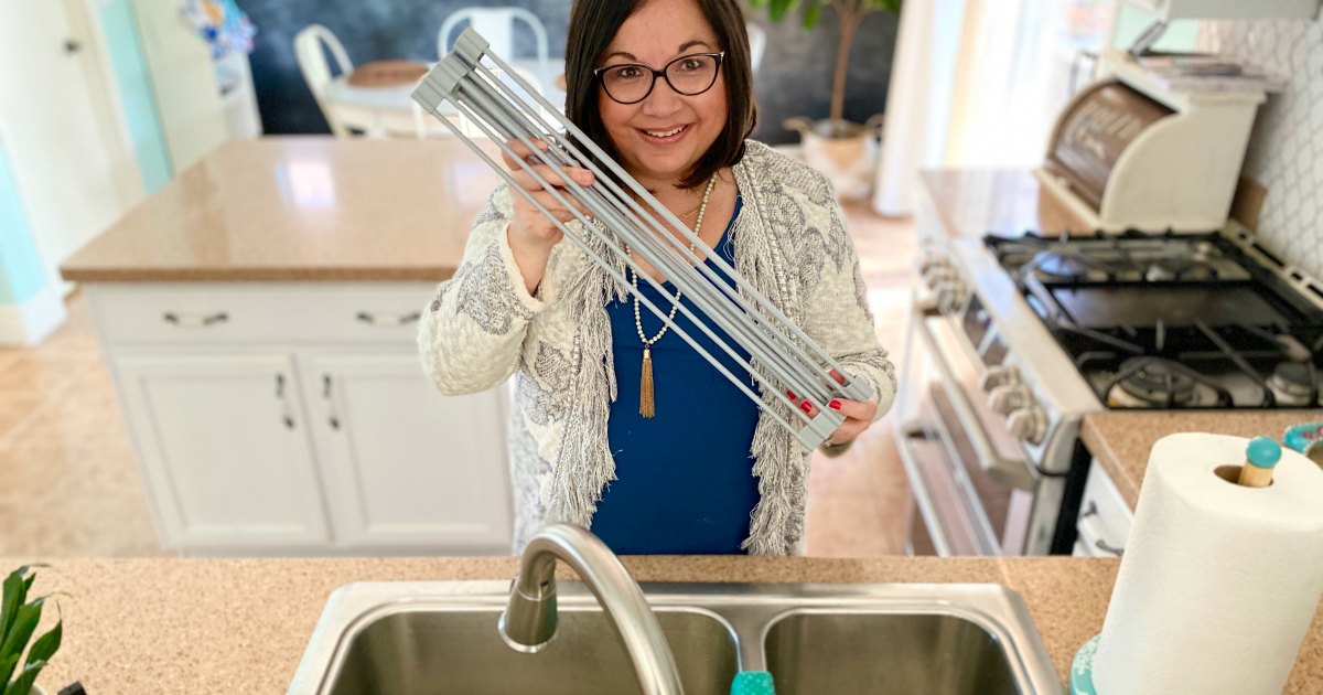 woman holding a roll-up kitchen drying mat