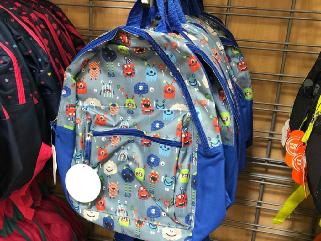 blue backpack hanging on store display
