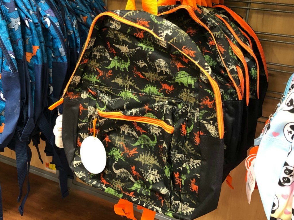 store display with backpacks featuring dinosaurs