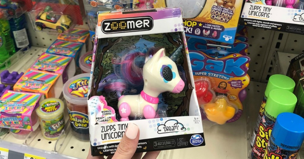 hand holding unicorn electronic toy in store