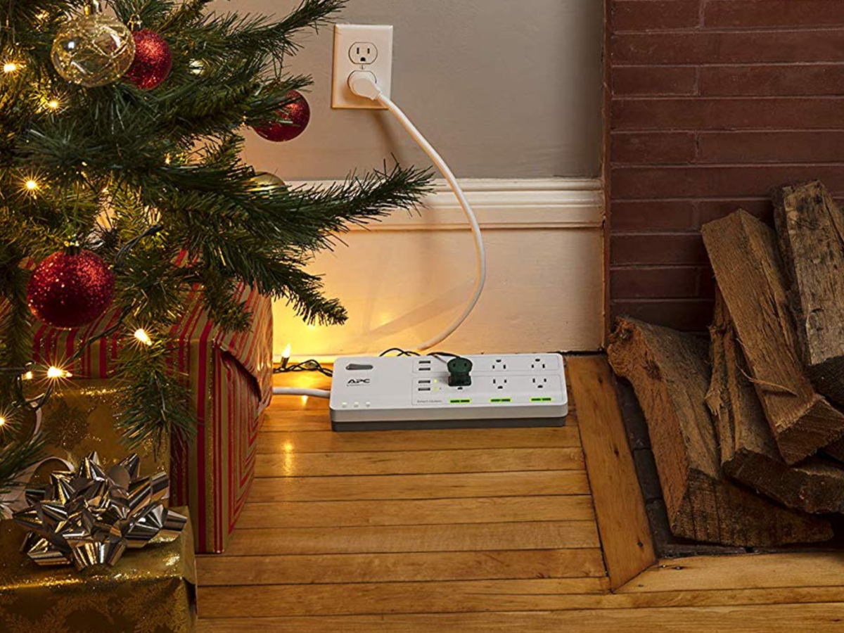 APC 6-Outlet Surge Protector Power Strip with 3 Alexa Smart Plugs in livingroom with Christmas tree plugged in
