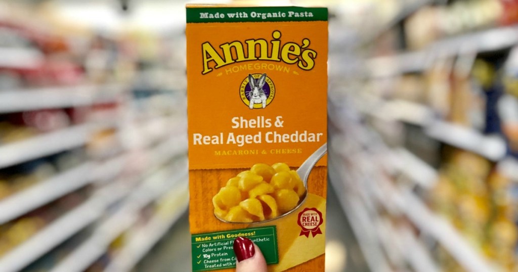 Annie's brand macaroni and cheese in box at store in hand