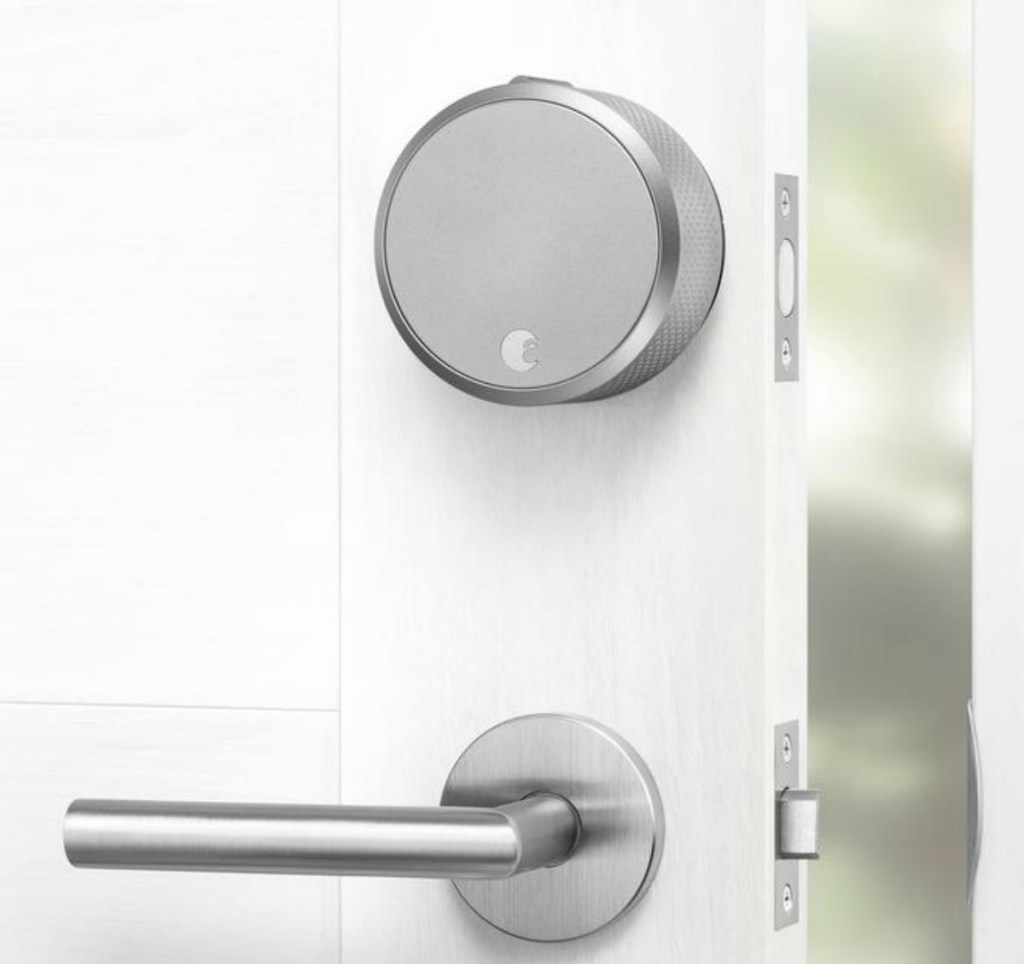 Silver smart lock in white door with coordinating handle