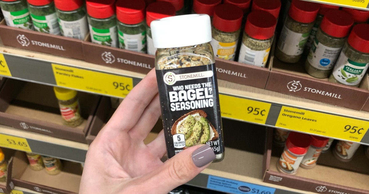 Woman holding bottle of Who Needs the Bagel Seasoning made by Stonemill