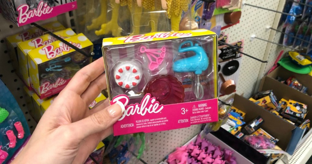 woman holding Barbie hand mixer set in store