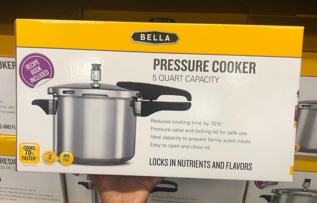 Bella five quart pressure cooker in package in front of display shelf at Macy's
