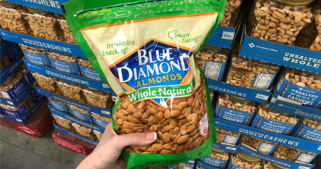 woman's hand holding a club-sized bag of Blue Diamond Almonds
