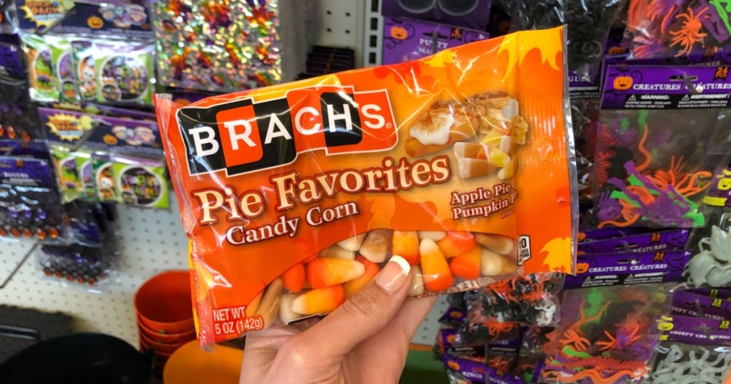 Woman holding bag of Brach's Pie Favorites Candy Corn in Dollar Tree