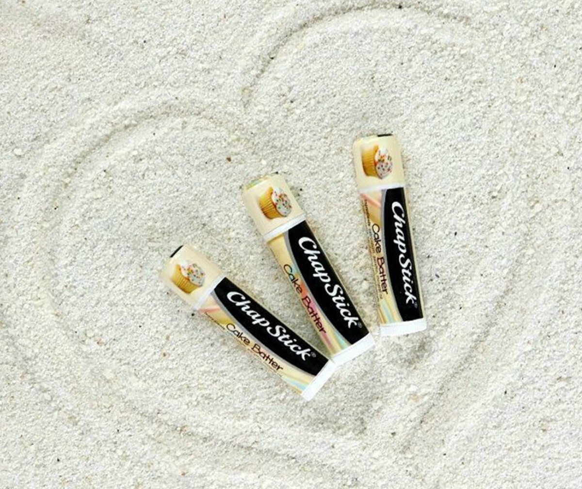 ChapStick brand lip balm in sand with heart drawn